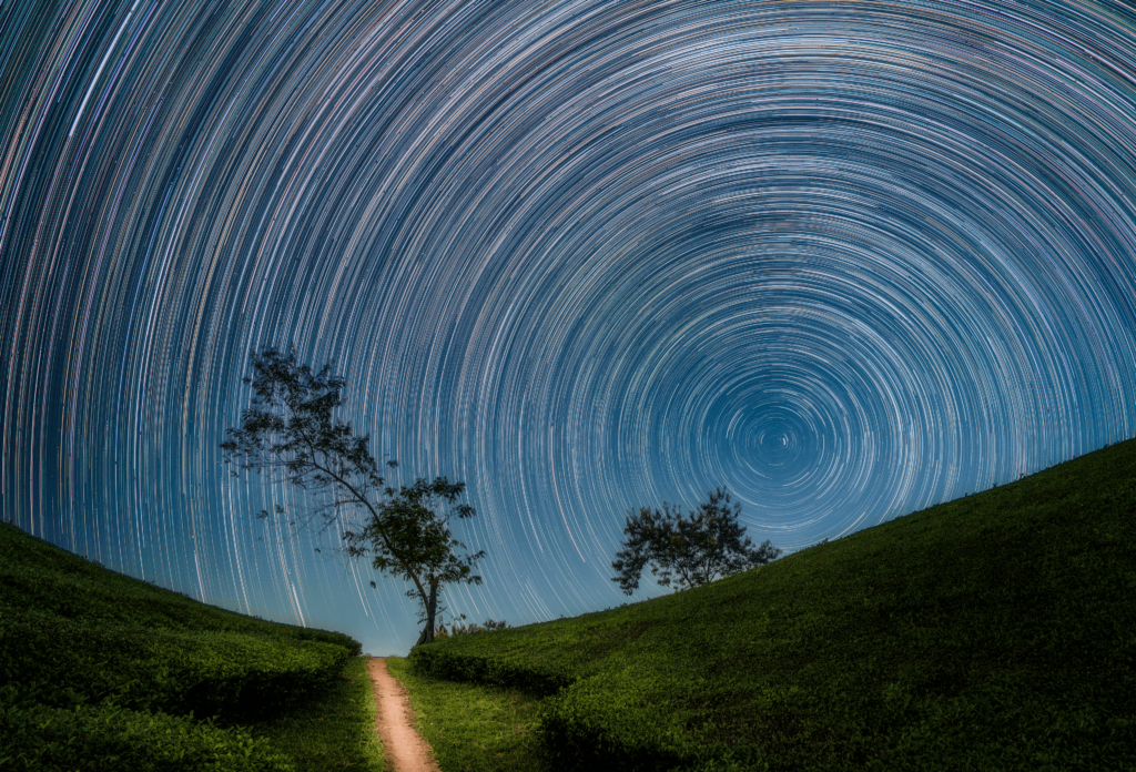 Captivating night sky star trails above serene hills in Phú Thọ, Vietnam.